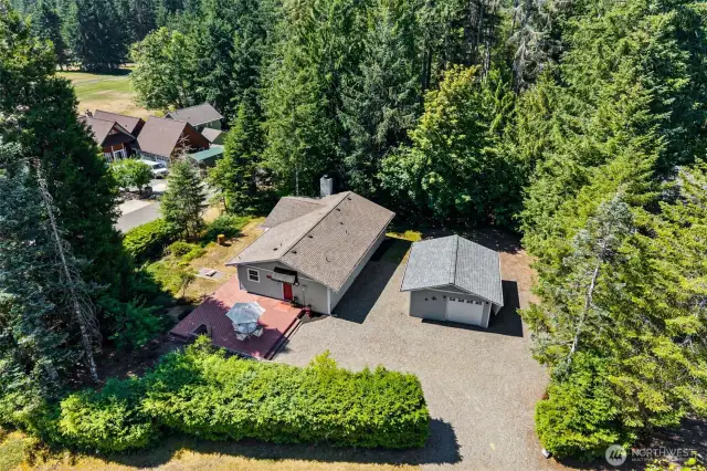 Aerial view of large corner lot and large parking area.