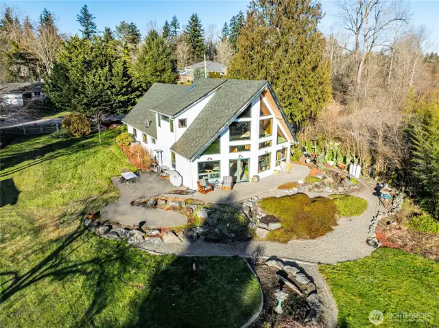 3 patios on south side of the home  Aggregate concrete walkway wraps around ¾ of the house, is wheelchair accessible on west side of the house,   with ramp on east side of house