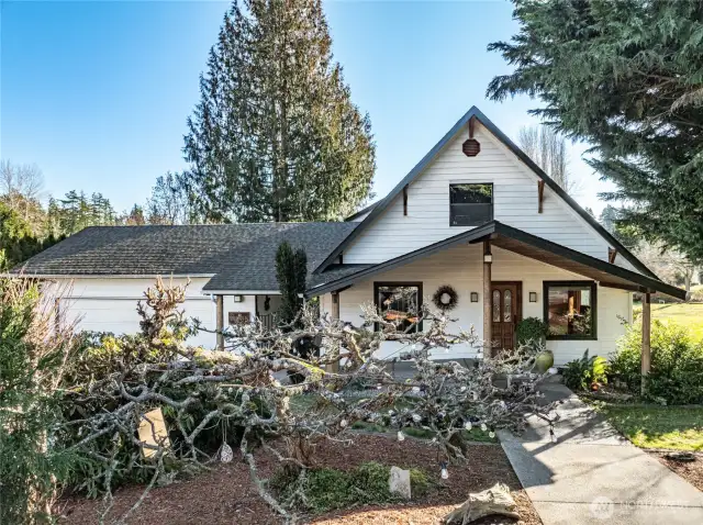 Vaulted covered entry with tongue-and-groove wood eaves  Front entrance door with beveled glass inserts  Aggregate concrete entry with wheelchair-accessible ramp to front door, as well as alternate aggregate concrete step