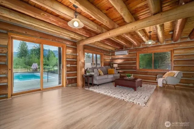 Slider that leads out to the wrap around porch and pool from living area