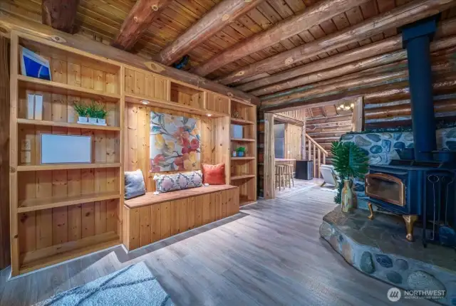 Built in bookcase and wood burning stove that connect the dining room and kitchen