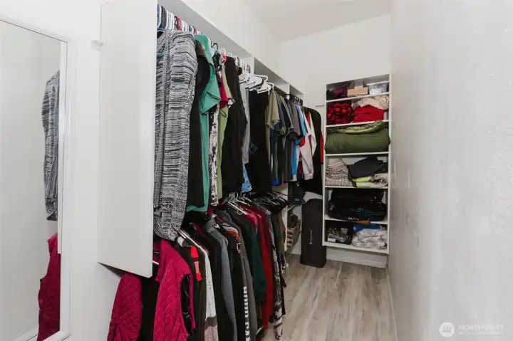 Primary walk in closet with organizers