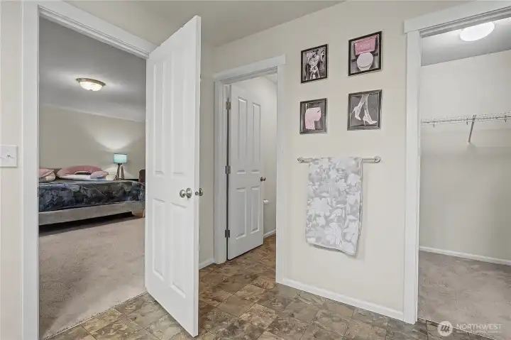 Primary bath view towards bedroom, walk-in closet to your right, separate water closet to your left.
