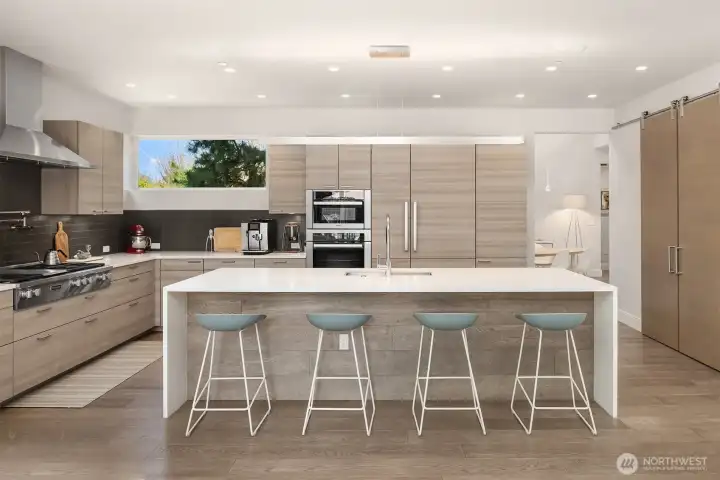 Chef’s kitchen with Poggenpohl cabinetry, Miele appliances, and a clean, architectural palette anchored by an oversized island.