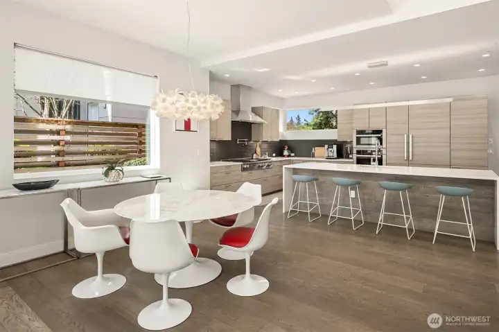 Dining area with sculptural lighting, positioned to connect seamlessly with the kitchen and outdoor living beyond.