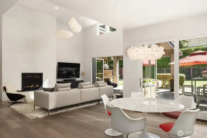 Light-filled dining and living spaces where volume ceilings and folding glass doors create a true indoor-outdoor experience.