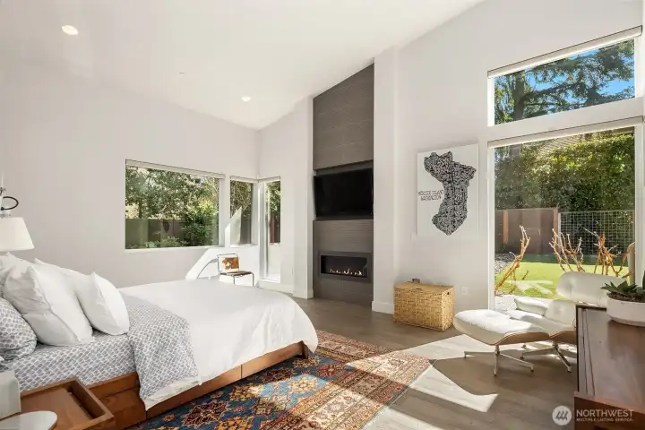 Primary suite with soaring ceilings, fireplace, and garden outlooks—private, quiet, and beautifully scaled.