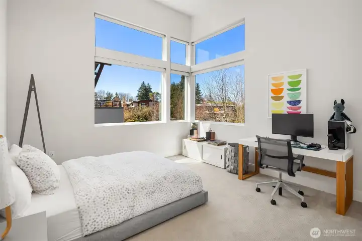 Corner bedroom with dual exposures, capturing natural light throughout the day.