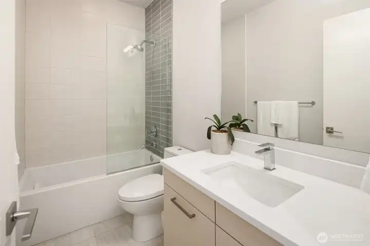 Well-appointed full bath with clean, modern finishes and tub/shower combination.