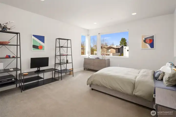 Generous additional bedroom with oversized windows and comfortable proportions.