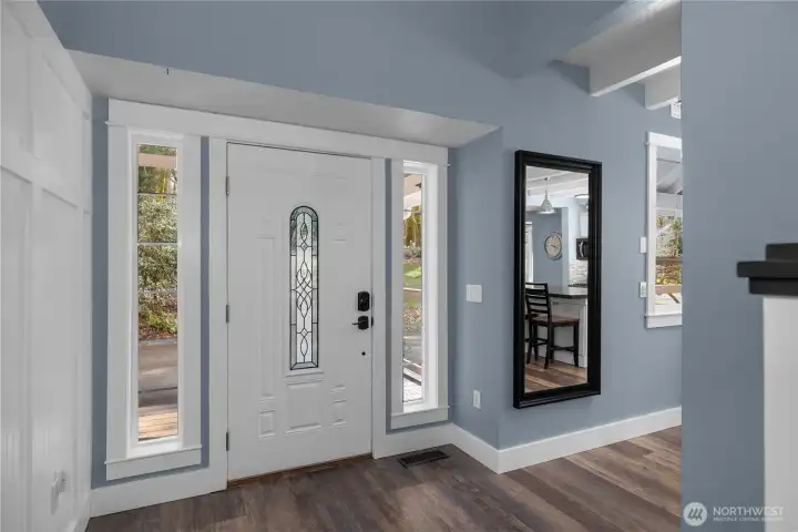 Bright entryway with tall ceilings and crisp finishes sets the tone inside.