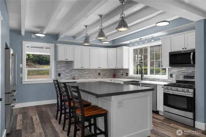 Thoughtfully designed kitchen offers abundant cabinetry, prep space, and casual dining.