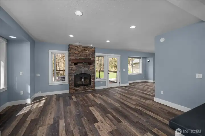 Expansive dining room and main living area is filled with natural light and centered around the fireplace.