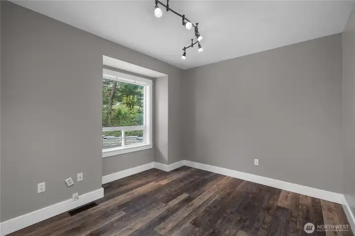 Bright main floor 2nd bedroom (near main floor full bath) provides flexibility for guests, office space, or everyday use.