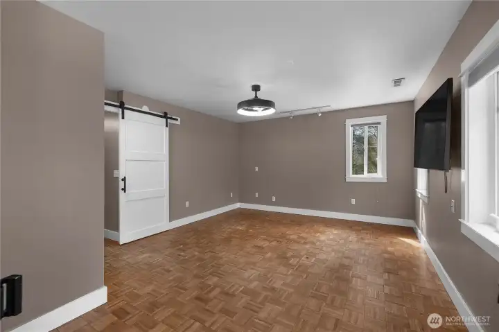 Spacious Primary BR with parquet floors - new stylish light/fan, attached TV included.