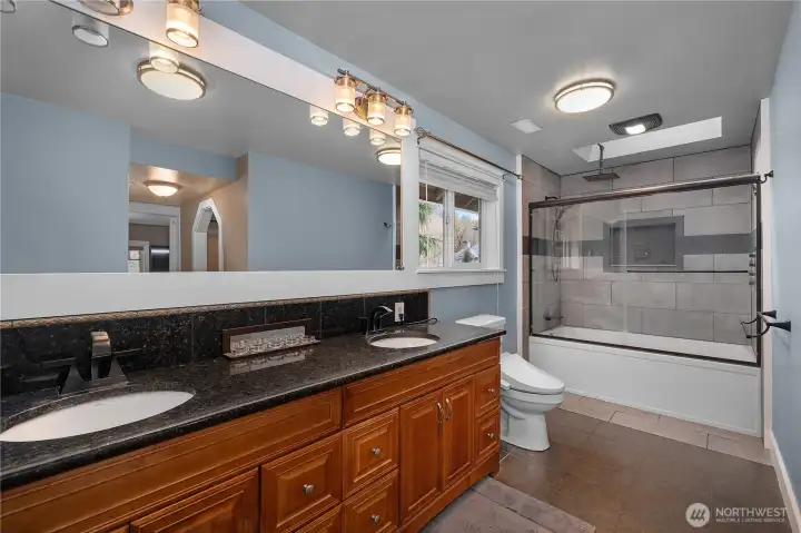 Well-appointed bath offers dual sinks, generous counter space, and a spa-like feel.