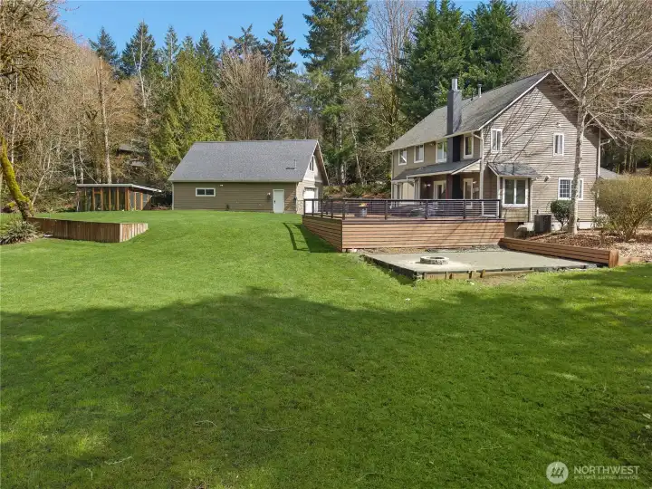 Great overall view of the home, shop, yard, and the REALLY NICE hen house. 2 firepits, a propane on the deck and a wood fire pit in the sand area.