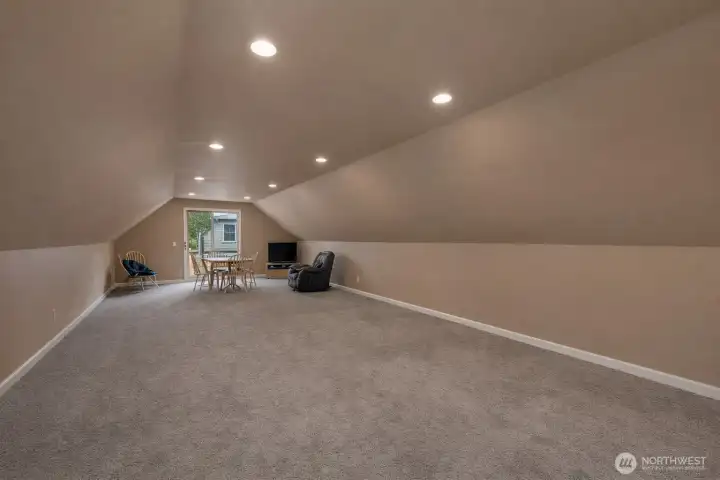 Finished upper-level garage space is ideal for hobbies, recreation, or a private retreat. This is a 'de staged' photo... We cleaned up the photo by removing personal items.