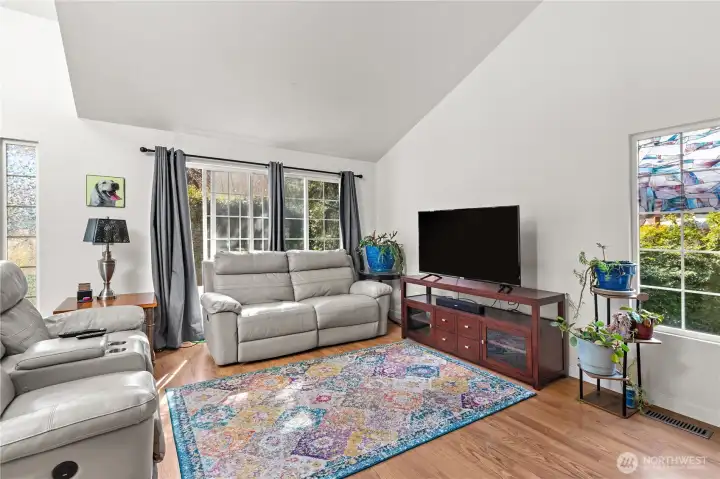 Enter to the corner living with vaulted ceilings.