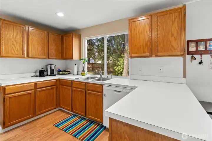 Pretty efficient kitchen with view to backyard.