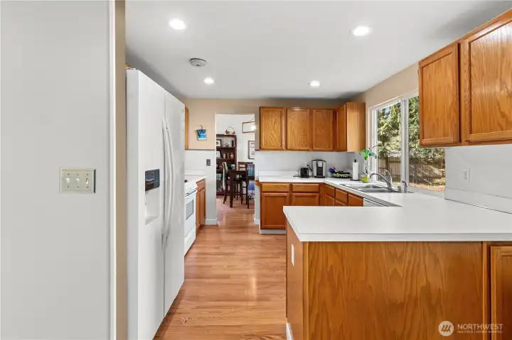Straight shot from the kitchen eating area through the kitchen to the dining room.