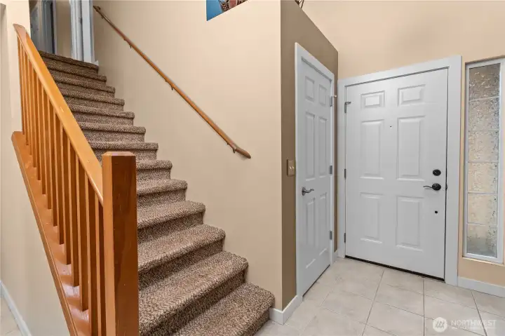 These are the same stairs from previous photo, leads to the upstairs.   Front door main entrance is to the right.