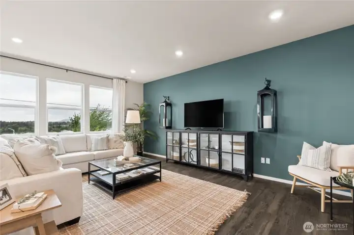 Extended low maintenance laminate flooring in entry, family room, kitchen and dining room. Photos are for representational purposes only.  Colors and finishes may vary.