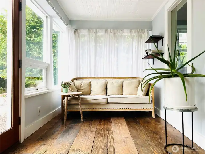 Enter into the sunroom, perfect for reading while waiting for a friend, a place to change from your inside to your outside shoes (a PNW custom) and the perfect place to winter over your potted plants.