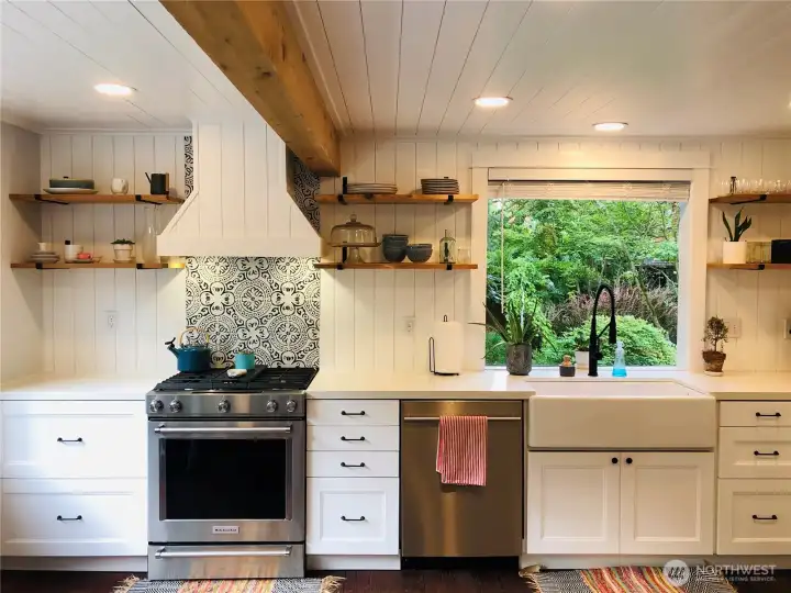 The kitchen has been totally remodeled. New everything. Again, modern finishes combine well with the wood floor and rough hewn beam.
