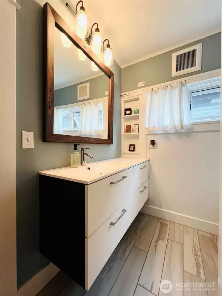 Downstairs full bath with clean, modern finishes.