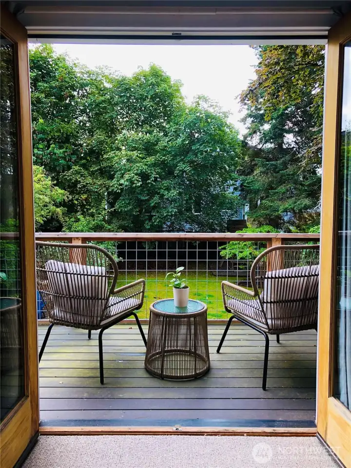 This deck overlooks the beautiful yard and is off of the primary.