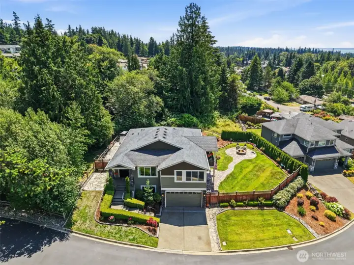 Bird's eye view, front elevation. Three car tandem garage plus driveway and off-street parking.