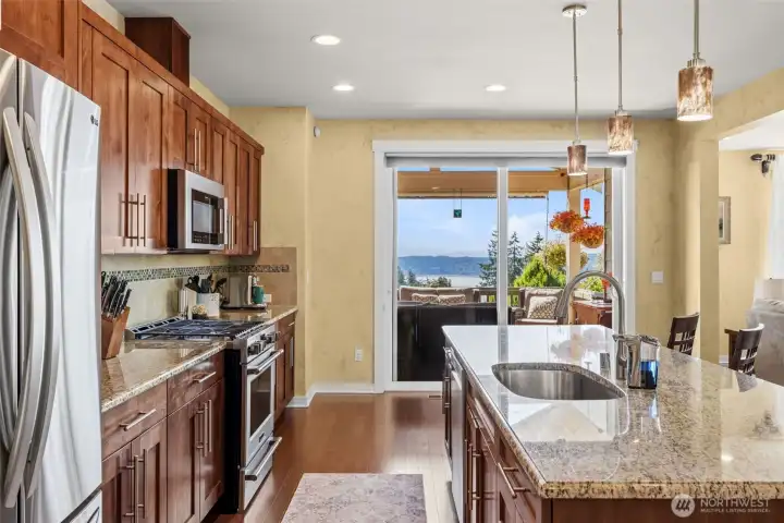Newer kitchen appliances stay with the home. Additional table space in front of glass sliding door.
