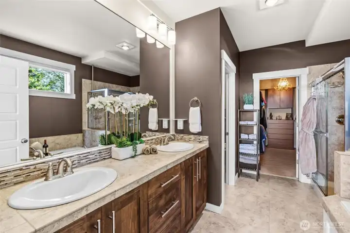 Luxurious bath, tub, separate shower, private lavatory, custom walk in closet, and nearby utility room.