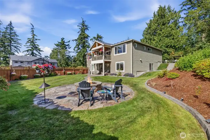 Immaculate mature landscaping and flagstone path to firepit for the enjoyment of endless starry nights.