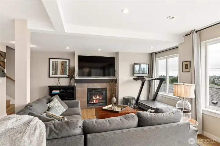 Open floor plan with abundance of light is great for everyday living but exceptional for entertaining. Living room with gas fireplace and west facing windows to the view. Open floor plan with abundance of light is great for everyday living but exceptional for entertaining. Living room with gas fireplace and west facing windows to the view.