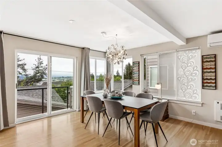 The dining area continues the openness of the home with sliding glass doors out to enjoy the view of the mountains and Sound. The dining area continues the openness of the home with sliding glass doors out to enjoy the view of the mountains and Sound.