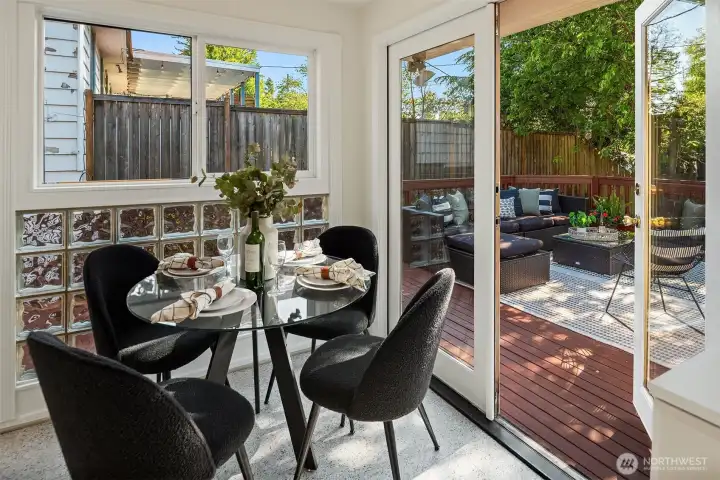French doors open directly to the deck, creating an easy indoor/outdoor flow for dinner parties, summer evenings, and morning coffee in the garden.