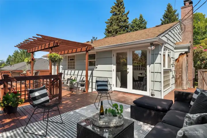 Designed for real outdoor living, the deck offers space to lounge, dine, entertain, and enjoy the garden setting from multiple access points.