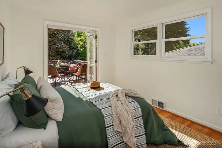 Wake up to greenery, birdsong, and direct access to your own private deck — a rare indoor/outdoor connection that makes the home feel special.