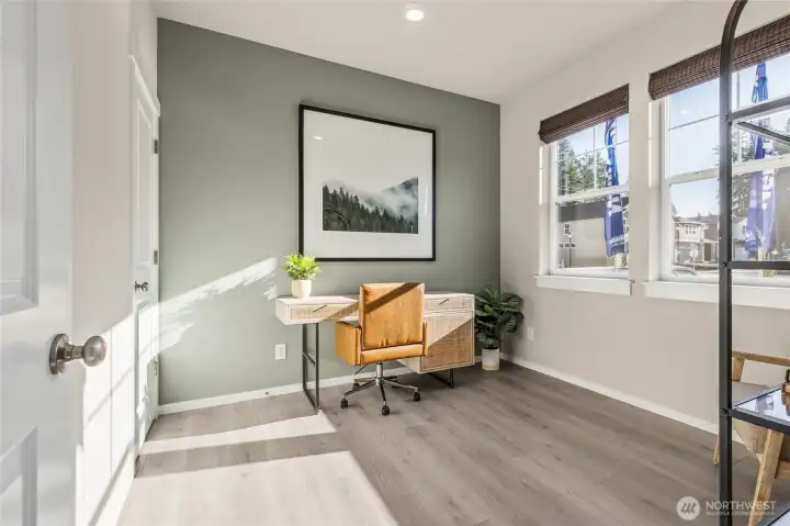 Bright main floor bedroom or office space with closet.  Finishes and colors may vary.