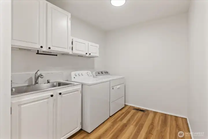 Completely Remodeled Utility Room with New Flooring, Freshly Painted Cabinets