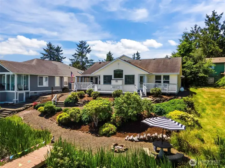 Lakefront living at its Finest! Perfect blend of tranquility and coastal convenience in this beautifully maintained custom home on shores of Duck Lake, located 10 min from ocean. This 2849 sq ft waterfront retreat is ideal for both everyday living and entertaining. Perfect for work from home job with Starlink installed. The bright & inviting great room showcases soaring vaulted ceilings, cherry hardwood flooring, expansive east-facing windows and a cozy propane fireplace that perfectly frames the stunning lake views. The adjoining chef's kitchen features double ovens, custom cabinetry, decorative backsplash, wine cooler fridge, spacious pantry, and a large eating bar. French doors open to covered deck for seamless indoor-outdoor living. Private main level primary is true retreat, complete with French doors leading to a secluded deck overlooking the lake, a spacious walk-in closet, and an ensuite with dual vanities. Two additional bedrooms and full bathroom are also on main floor. Upsta