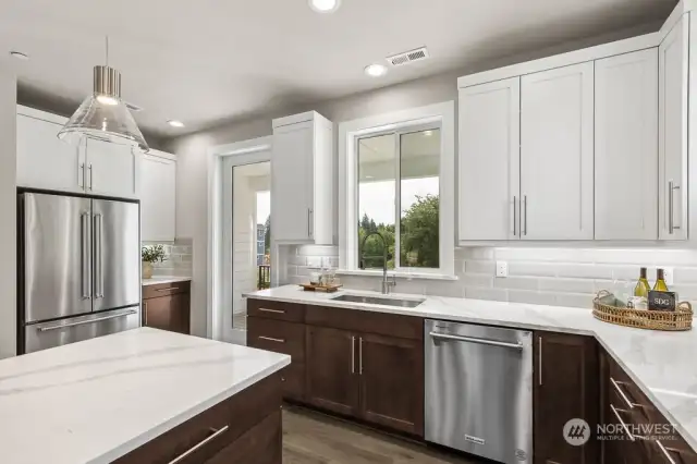 Undercabinet lights and the full height tile backsplash highlight the beauty of this kitchen!