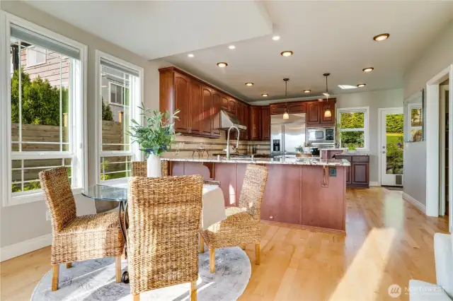 Large kitchen also has access to rear yard & patio thru showroom door in rear of photo.  Wine bar thru door way to right opens to walk in pantry.