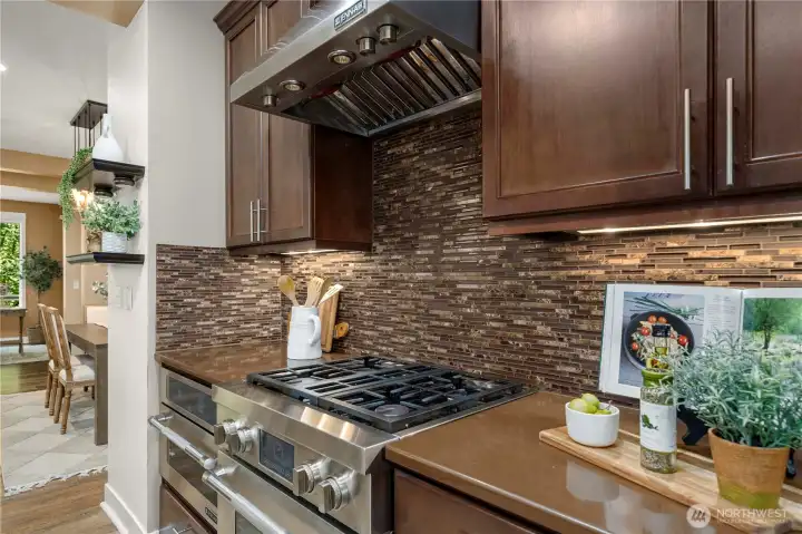 Top tier JennAir appliances and hood vent, stunning full height backsplash and classic cabinetry.