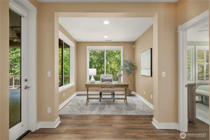 Spacious den with expansive windows (with Hunter Douglas window coverings) overlooking the permanent greenbelt.