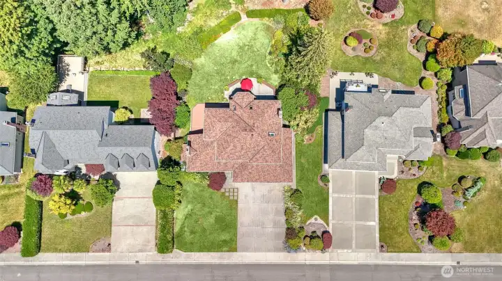 Enjoy this spacious extended driveway leading to a 3 car garage ensuring plenty of parking. Level shy half acre property.