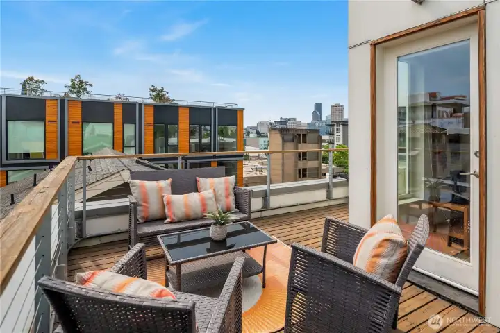 The expansive rooftop deck offers the perfect spot for lounging, entertaining, and soaking up city views.