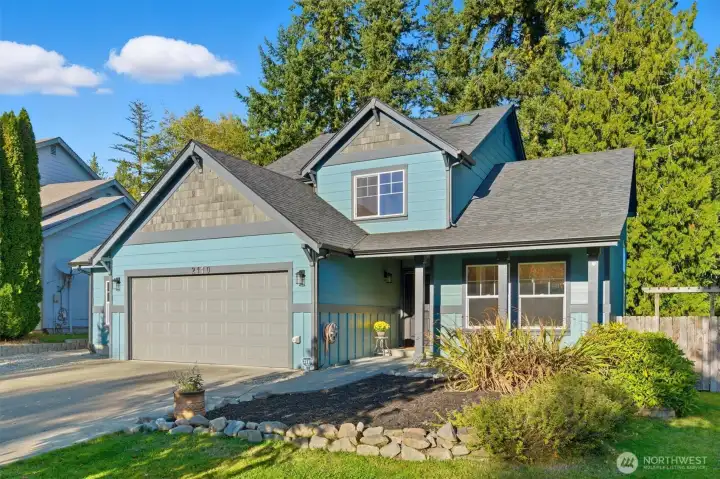 This listing features a spacious lot, lush landscaping, and a charming exterior.